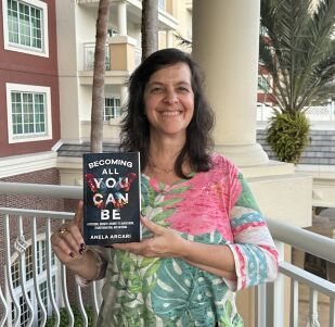 Seshat Press author holding their book