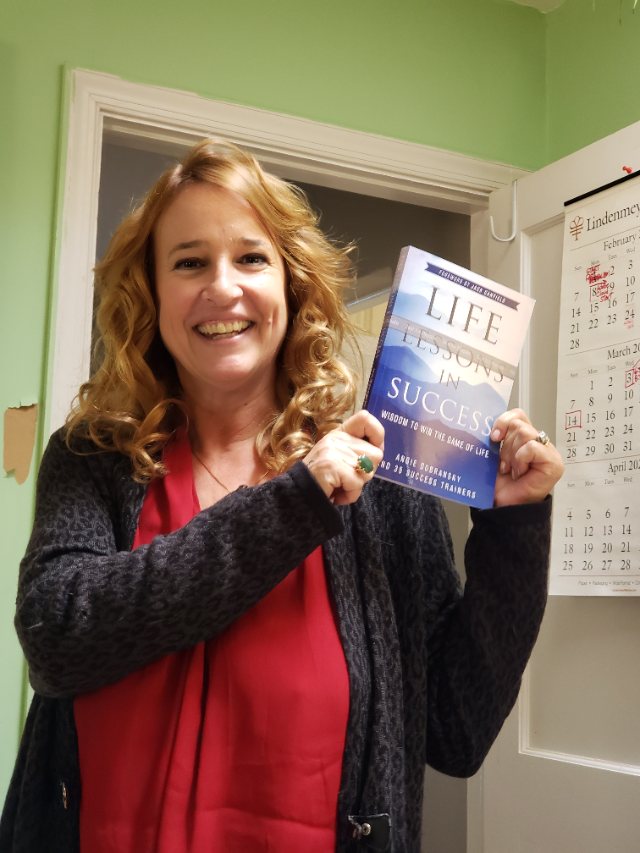 Seshat Press author holding their book