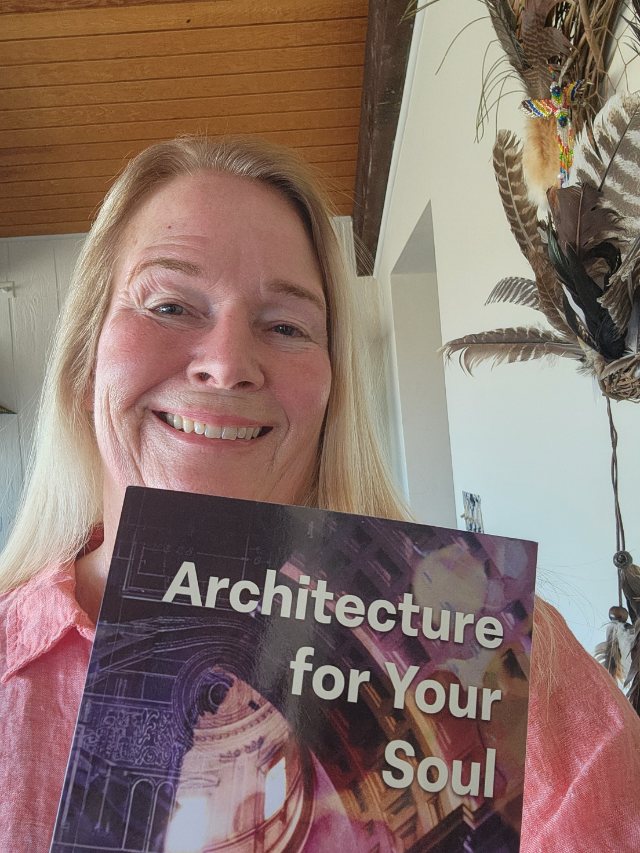 Seshat Press author holding their book