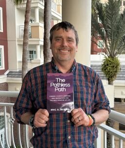 Seshat Press author holding their book