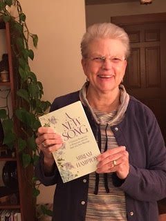 Seshat Press author holding their book