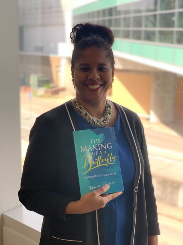 Seshat Press author holding their book